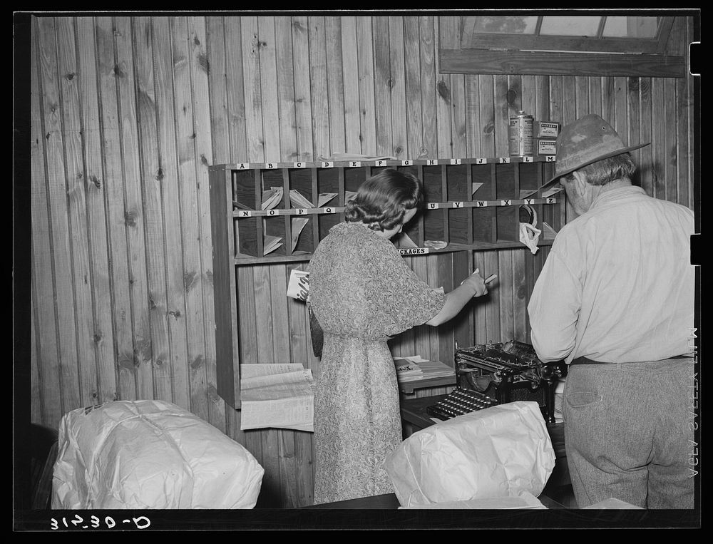 Getting the mail in cooperative store. Lake Dick, Arkansas by Russell Lee