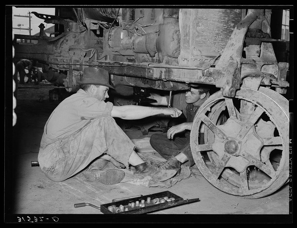 Member of cooperative association working on tractor. Lake Dick Project, Arkansas by Russell Lee