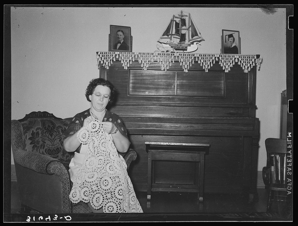 Wife of Joseph La Blanc crocheting in living room of her farm home near Crowley, Louisiana by Russell Lee