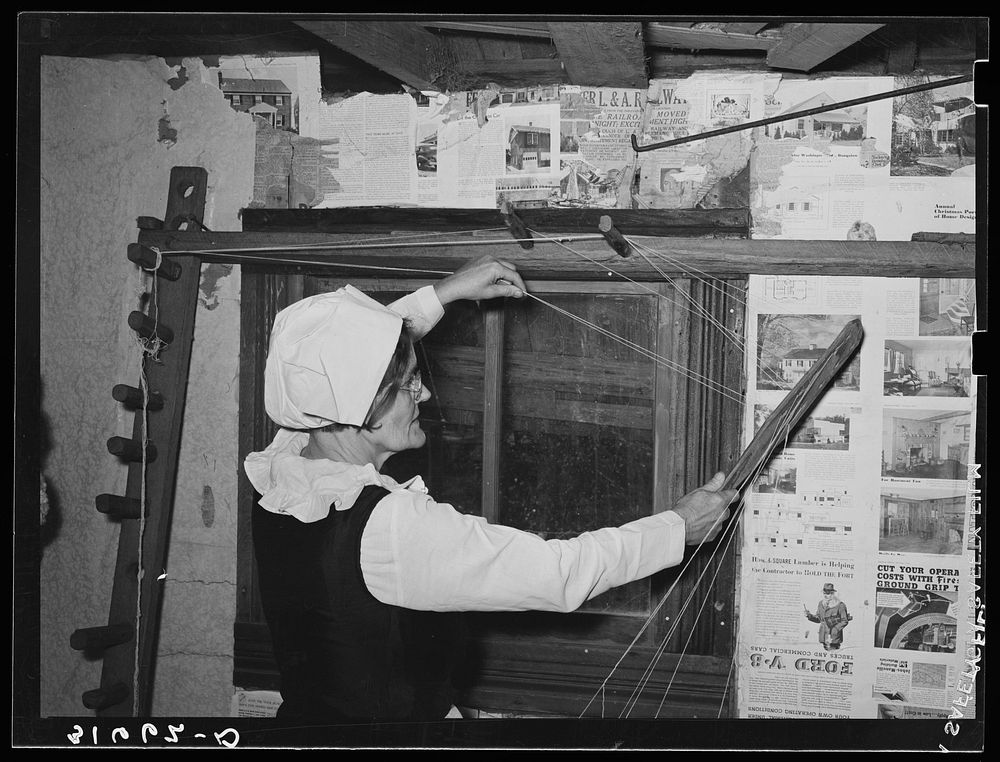 Madame Dronet threading frame preparatory to weaving. Erath, Louisiana by Russell Lee