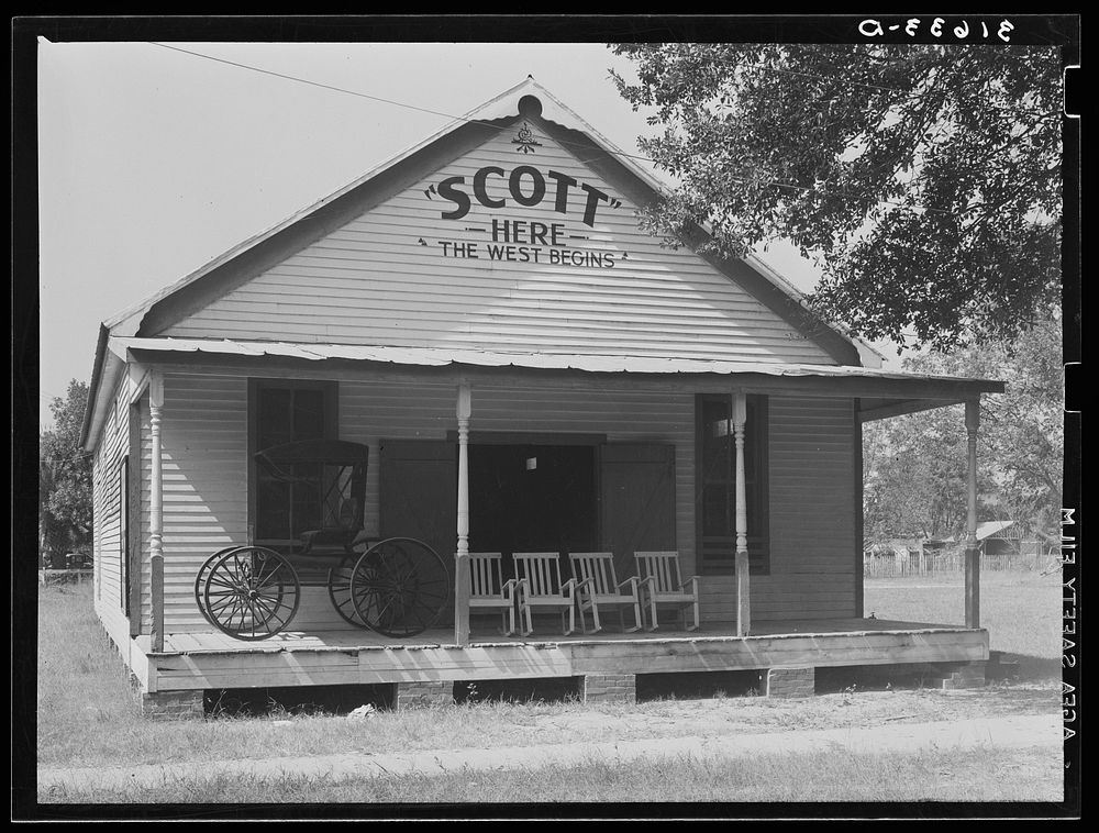 Building in Scott, Louisiana, proclaiming welcome to the West. This is on the O.S.T. by Russell Lee