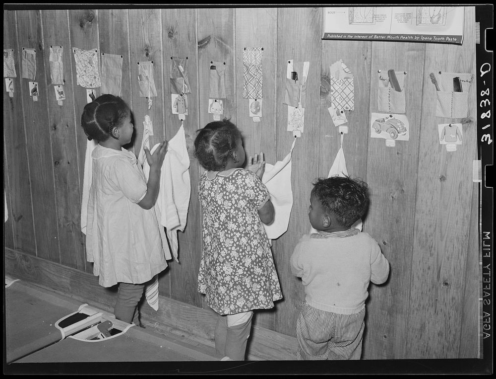 Child wiping hands after washing. Lakeview nursery school. Arkansas by Russell Lee