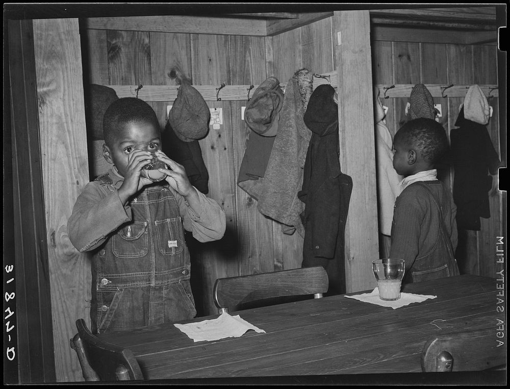 Children in nursery school drinking orange juice. This is given to them every morning at school. Lakeview Project, Arkansas…