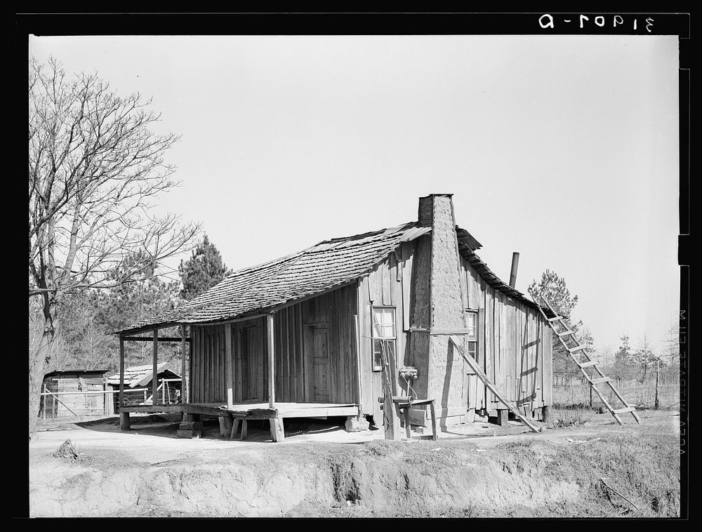  cabin, showing grass and mud chimney and broom made of corn husks for sweeping yard. Taylorsville, Mississippi by Russell…