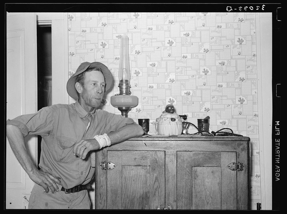FSA (Farm Security Administration) client leaning on icebox. Hidalgo County, Texas by Russell Lee