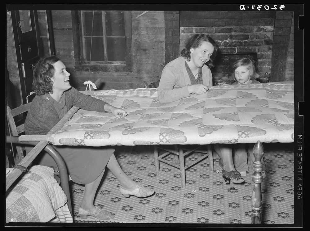[Untitled photo, possibly related to: Quilting in sharecropper's home near Pace, Mississippi. Background photo for Sunflower…
