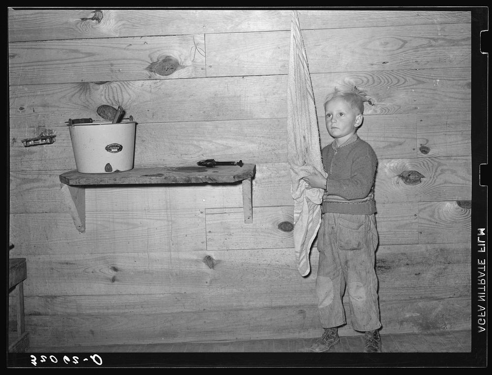 Son of tenant farmer washing hands. Near Pace, Mississippi. Background photo, Sunflower Plantation by Russell Lee