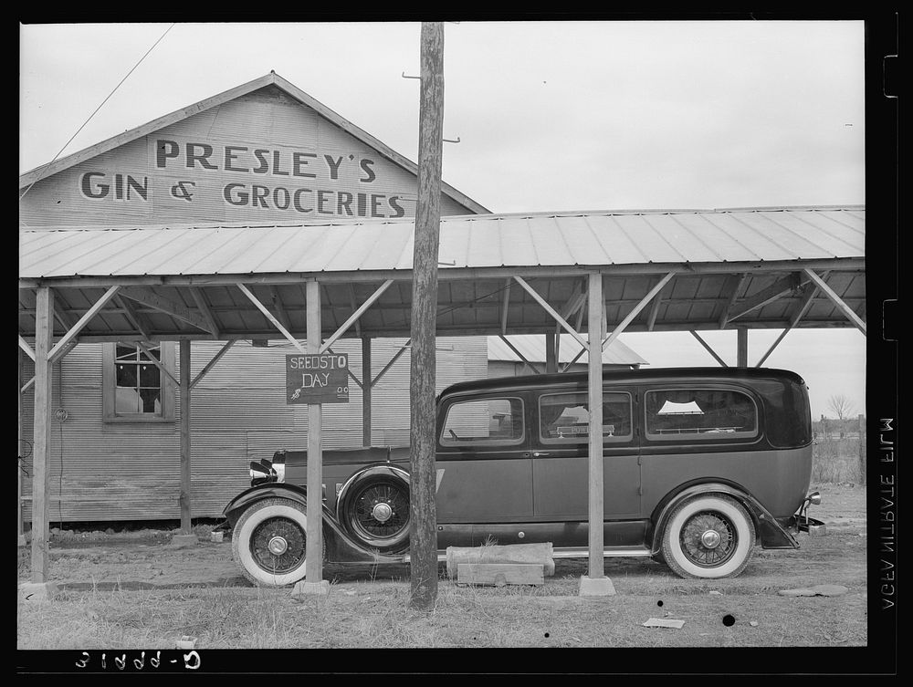 [Untitled photo, possibly related to: Funeral ambulance parked under gin shed. Mound Bayou, Mississippi] by Russell Lee