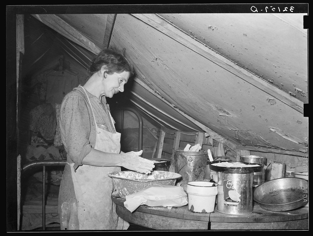 Migrant mother making biscuits in tent home near Mercedes, Texas. See 32108-D by Russell Lee