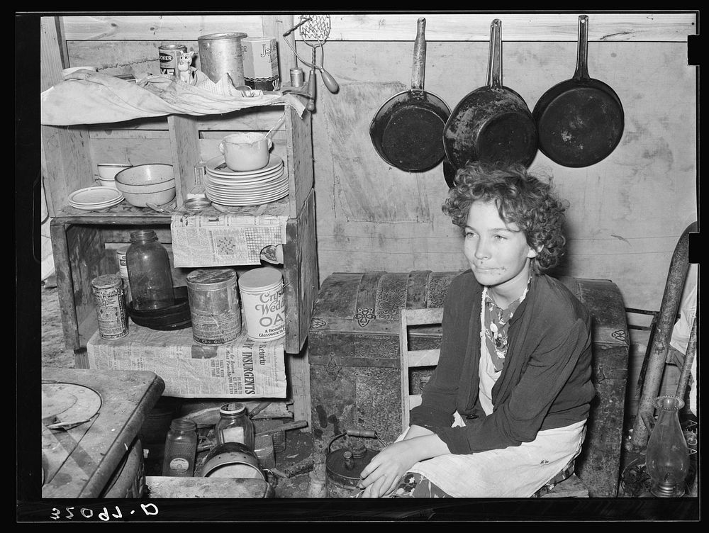 Daughter of former white labor contractor, now migrant worker, in tent home. Weslaco, Texas by Russell Lee