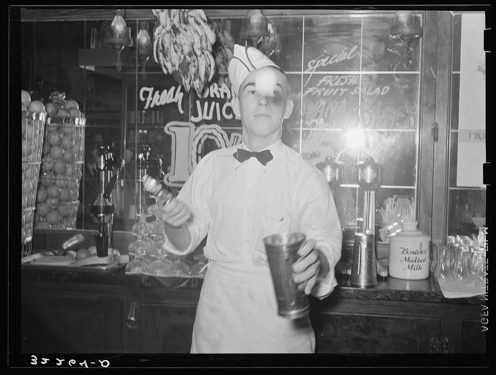 Soda jerker flipping ice cream into malted milk shakes. Corpus Christi, Texas by Russell Lee