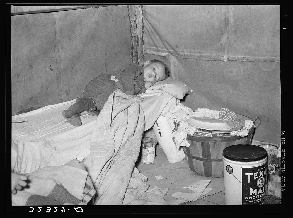 Child with measles in tent home of his migrant parents. Edinburg, Texas by Russell Lee