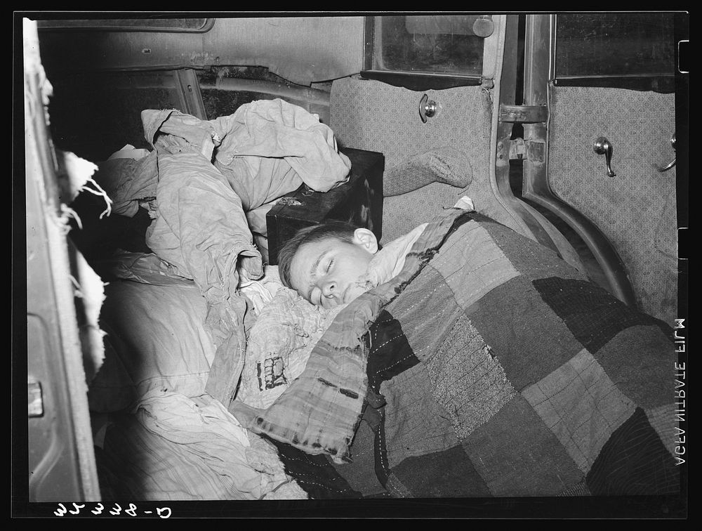 White migrant boy asleep in car. He came with his father from Houston to Edinburg, Texas by Russell Lee