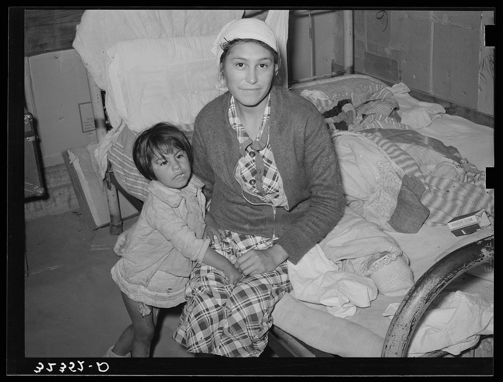 Mexican mother and child in home. Crystal City, Texas. This woman had given birth to baby on bed while she had an advanced…