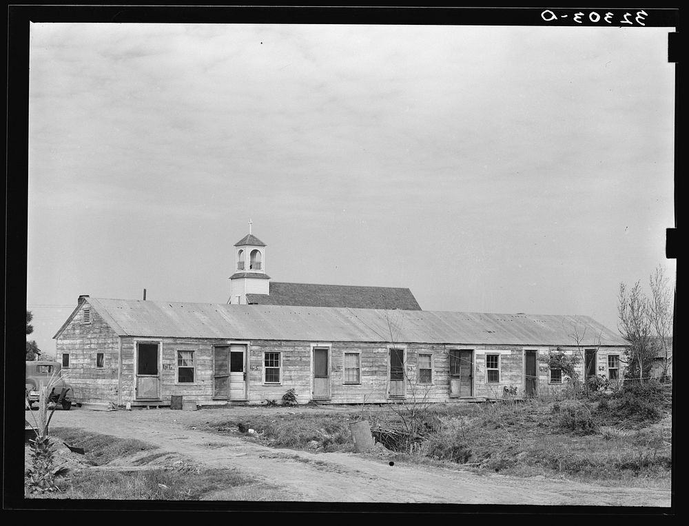 Mexican housing at Edcouch, Texas. Notice church in background by Russell Lee