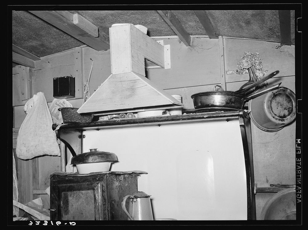 Kitchen range and homemade ventilator in trailer belonging to white migrant camped at Sebastian, Texas by Russell Lee