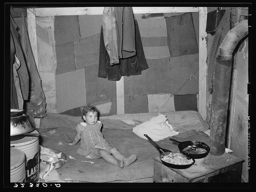 Interior of tent of white migrant family near Edinburg, Texas. Bed is on the floor. Tent was made of patched cotton…
