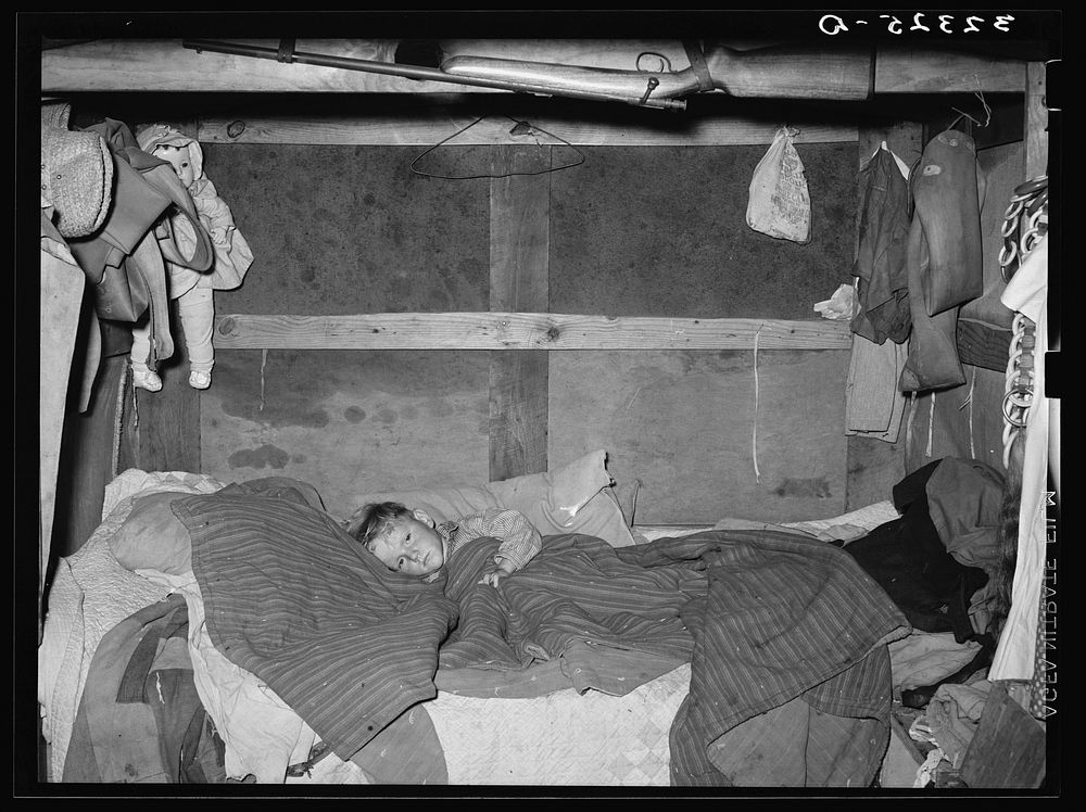 Sick child in bed in trailer home. Sebastian, Texas by Russell Lee