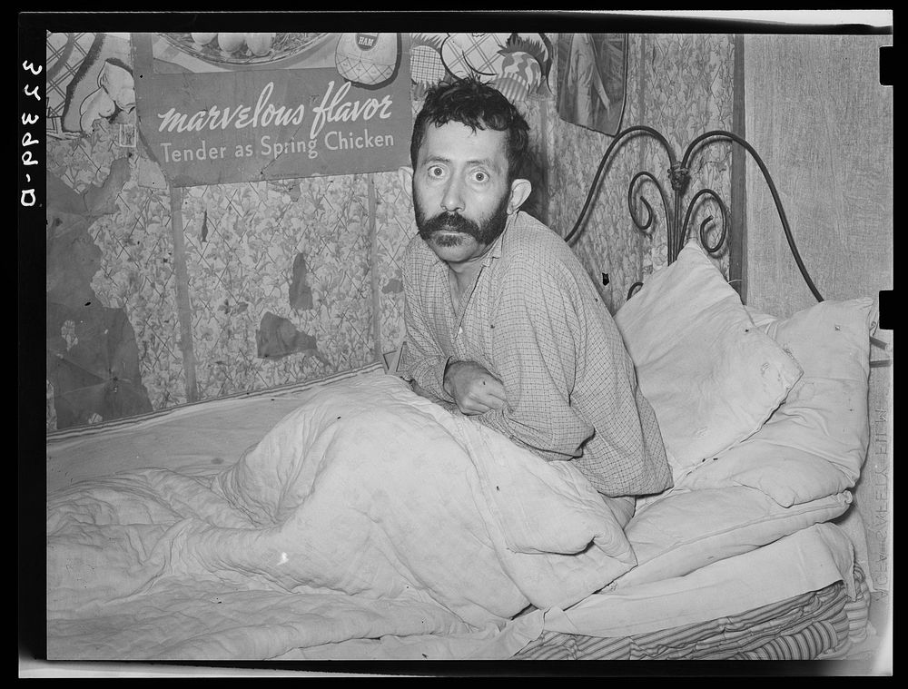 [Untitled photo, possibly related to: Mexican with advanced case of tuberculosis. He was in bed at home with other members…