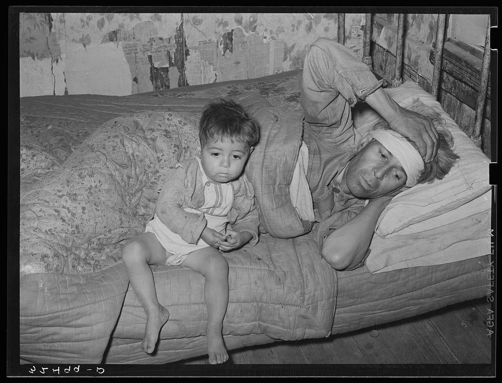 Mexican father and child. San Antonio, Texas. This family was living on relief. The father was obviously very sick. He said…