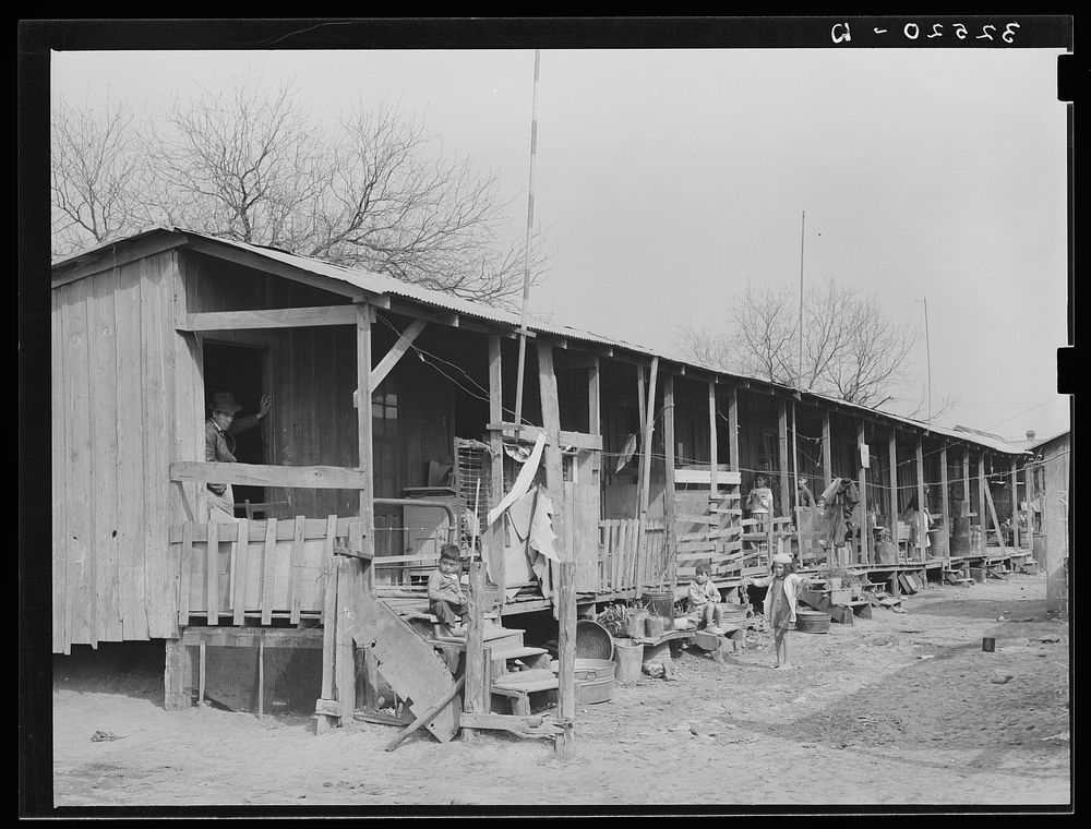 [Untitled photo, possibly related to: Row of houses facing on corral. San Antonio, Texas] by Russell Lee