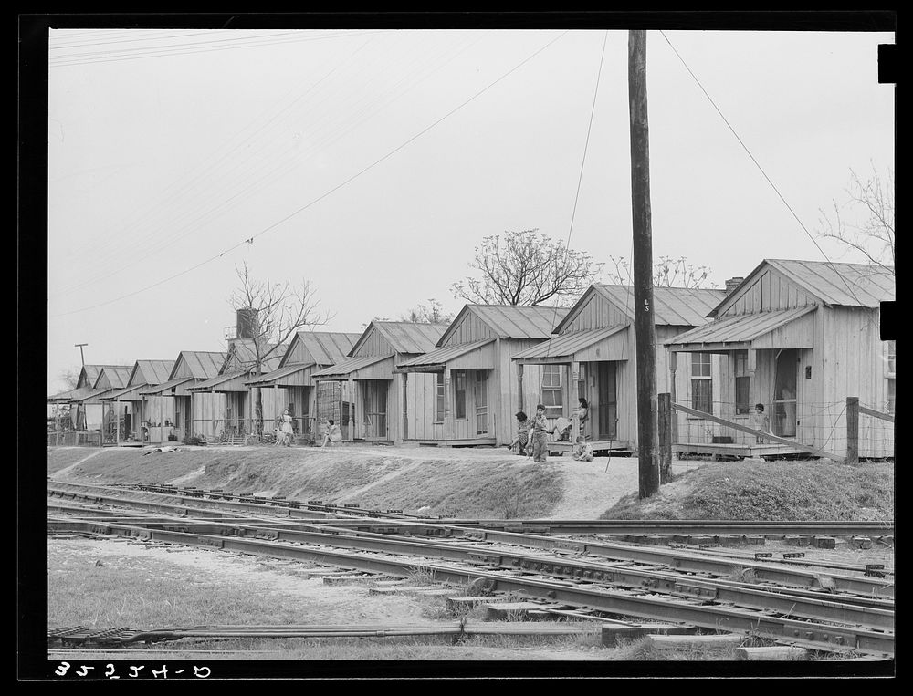 Row of houses along the railroad track. Mexican quarter, San Antonio, Texas by Russell Lee