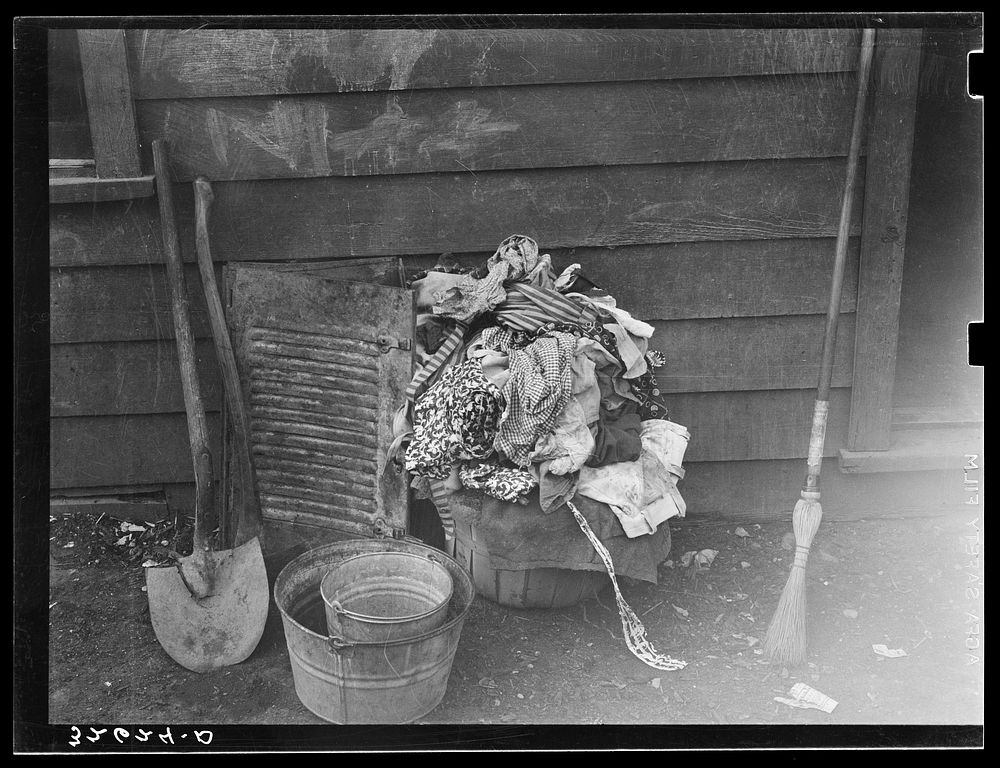 [Untitled photo, possibly related to: Laundry and household and garden tools. Mexican section, San Antonio, Texas] by…