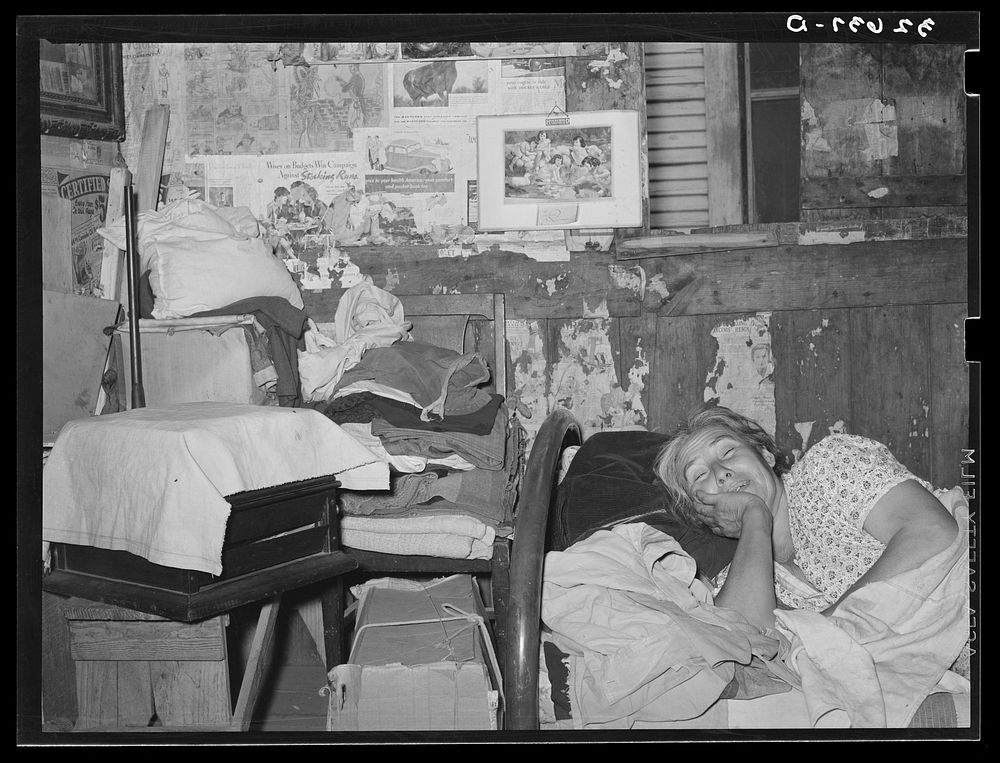 [Untitled photo, possibly related to: Mexican woman resting on bed in her home. San Antonio, Texas] by Russell Lee