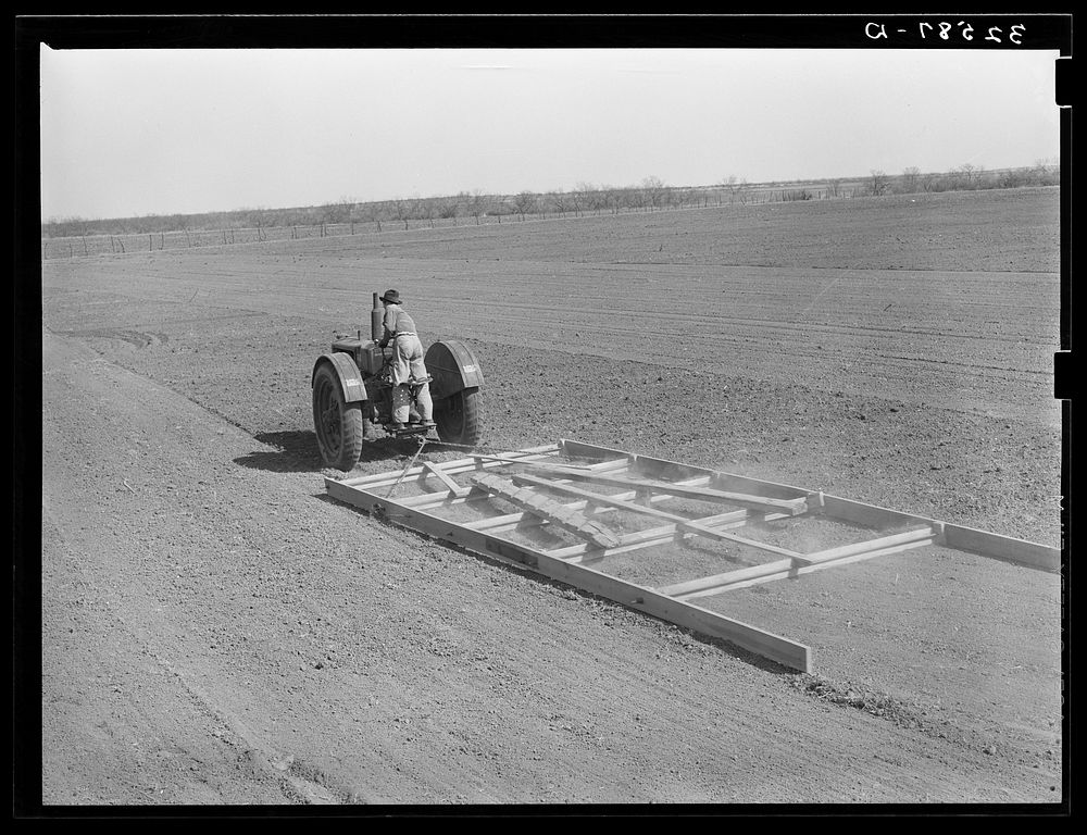 [Untitled photo, possibly related to: Tractor pulling wooden floater to smooth the soil. El Indio, real estate development…