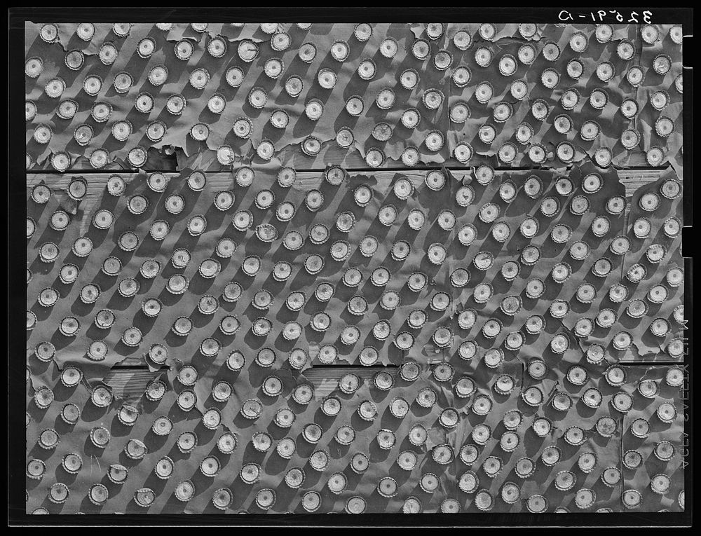 Detail of bottle caps decorating abandoned theater. Quemado, Texas by Russell Lee