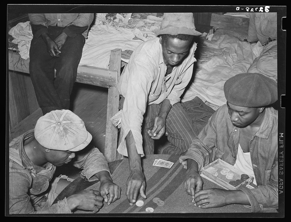 Poker game in  strawberry workers' bunkhouse. Hammond, Louisiana by Russell Lee
