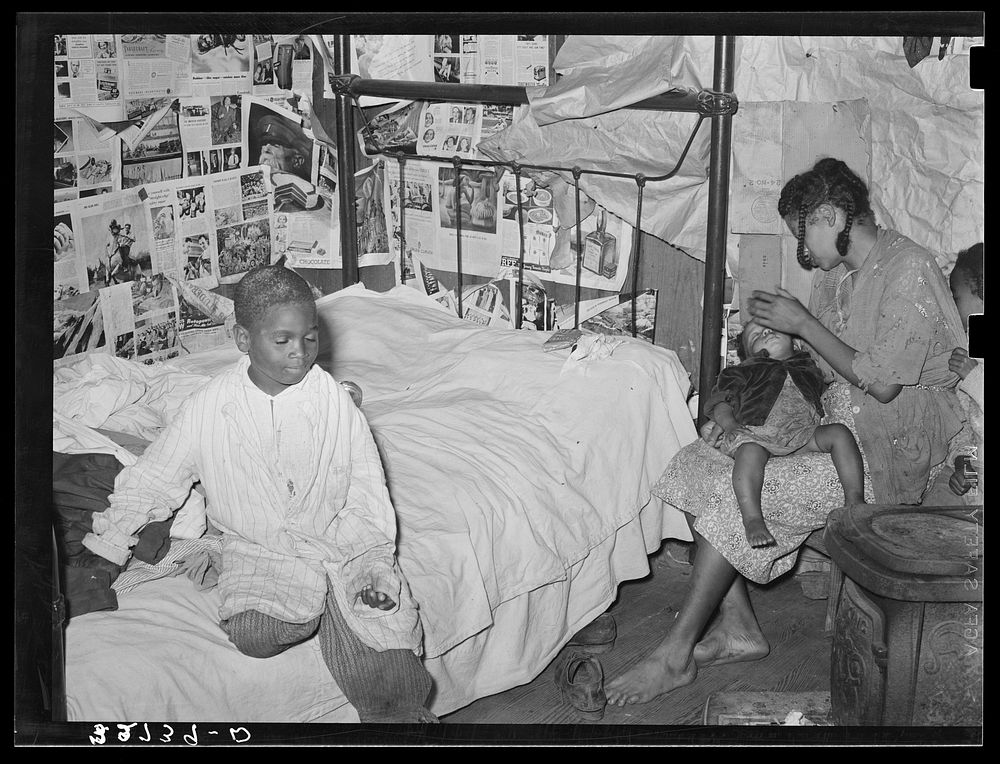 Mother and two children in house provided for workers in strawberry fields near Independence, Louisiana by Russell Lee