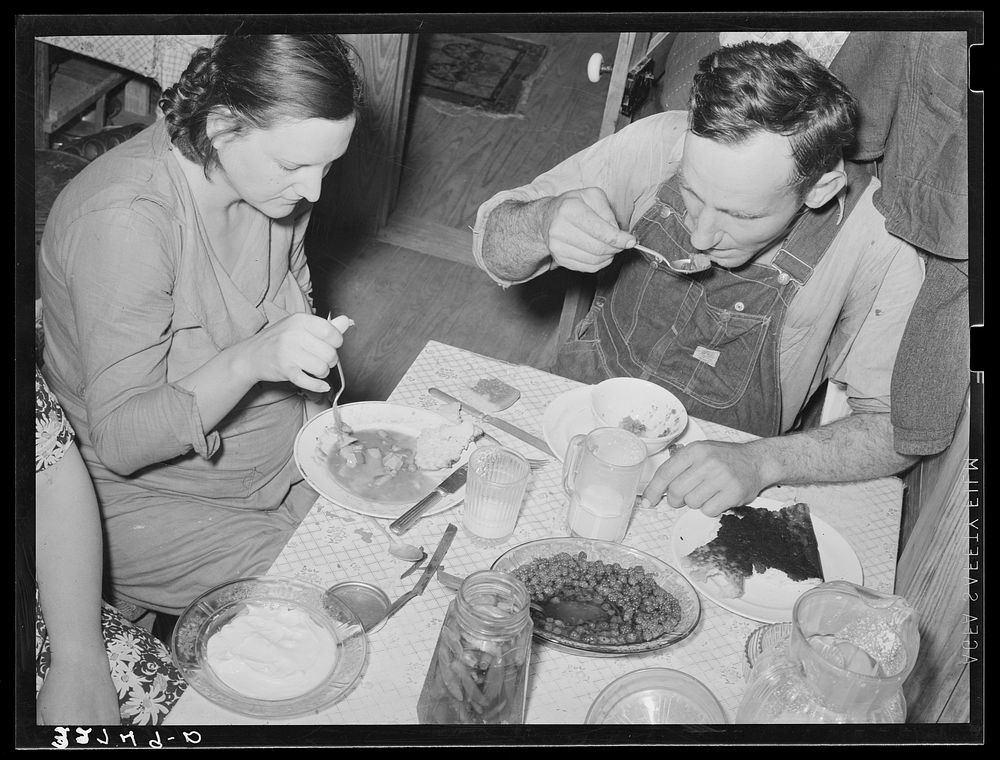 East Texas farmer and his wife eating dinner. Marshall, Texas by Russell Lee