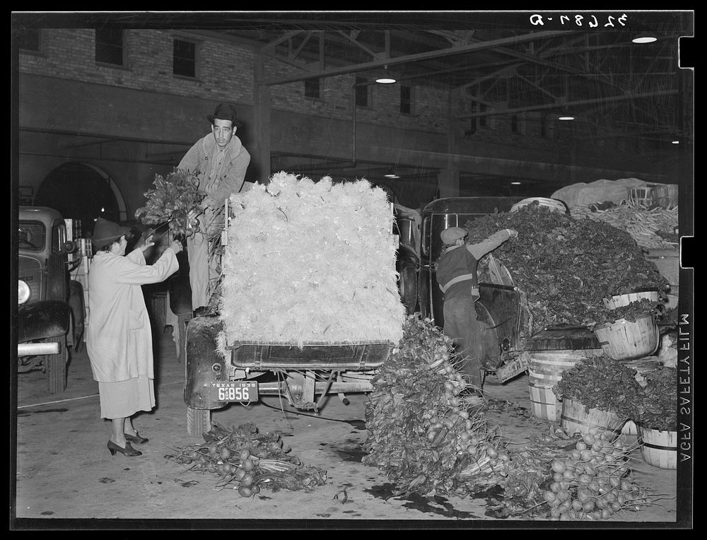 Unloading trucks at vegetable market. San Antonio, Texas by Russell Lee
