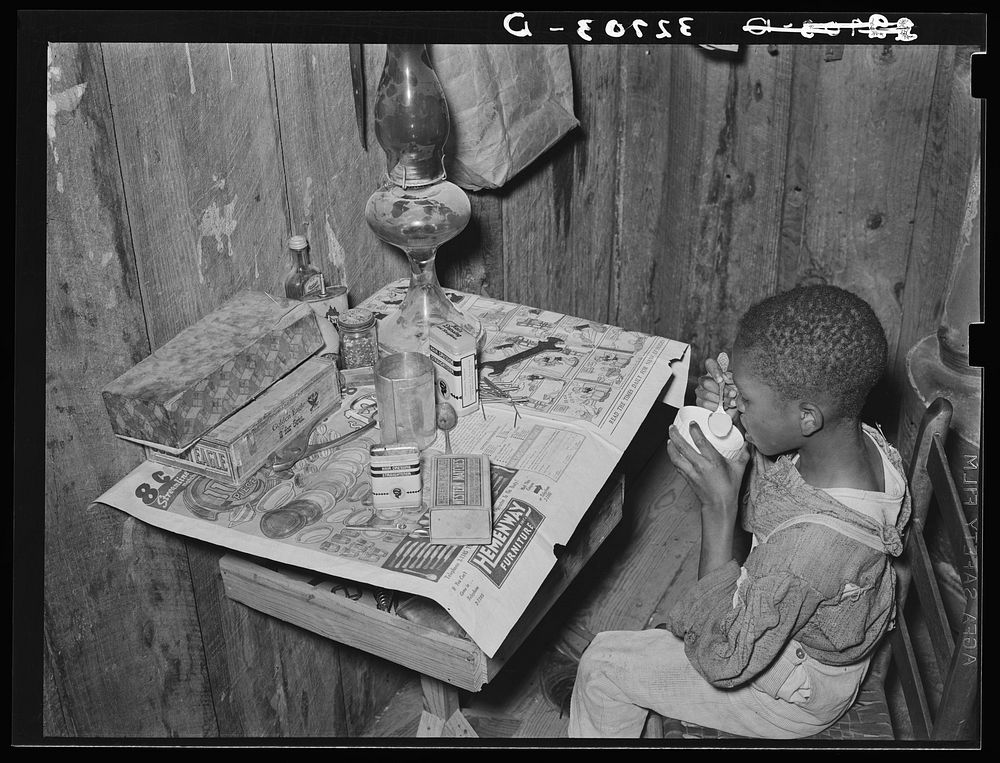 Boy drinking "milk" made of flour and water. He was sick and his mother, the wife of a sharecropper, had given him. Near…