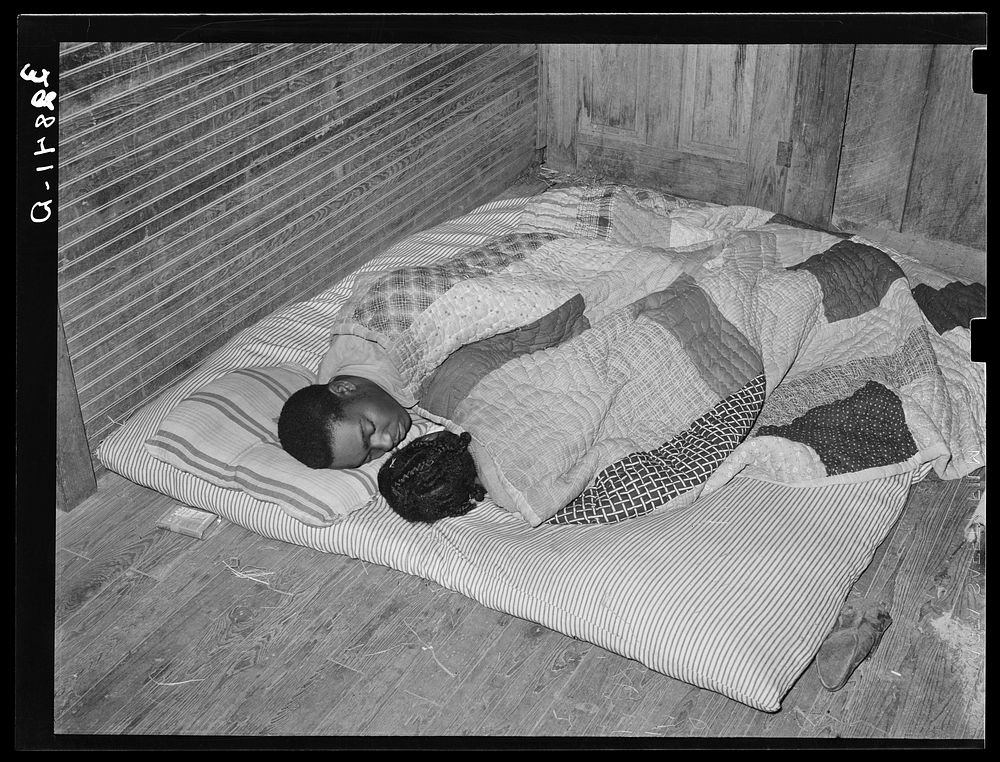  couple, intrastate migratory workers, sleeping on the floor. Near Independence, Louisiana by Russell Lee