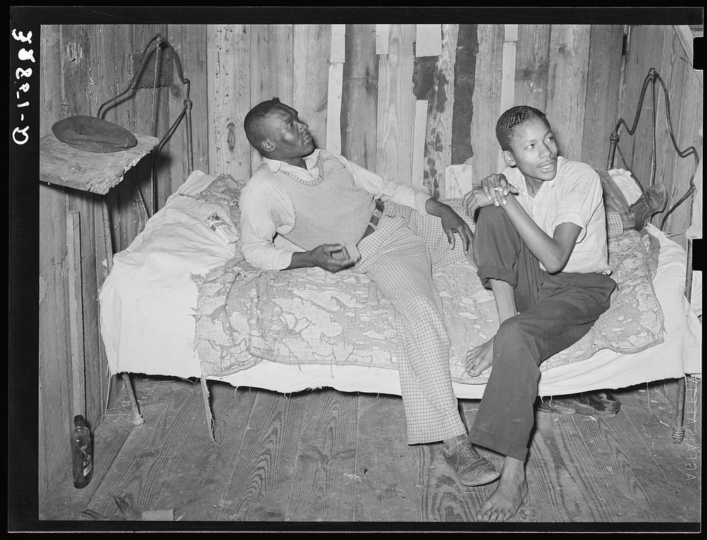  strawberry pickers on bed in their quarters near Hammond, Louisiana by Russell Lee