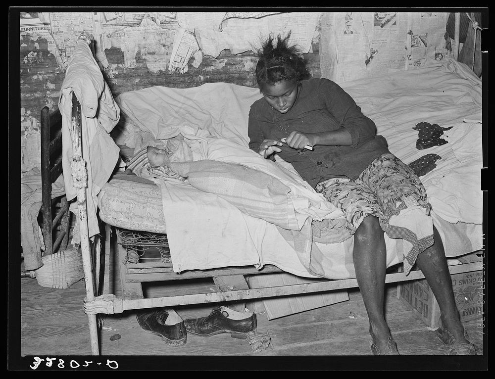  mother and child on bed in their cabin near Jefferson, Texas by Russell Lee