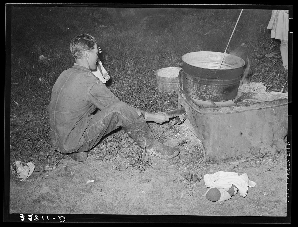 [Untitled photo, possibly related to: Migratory berry picker putting trash into fire. Near Ponchatoula, Louisiana] by…