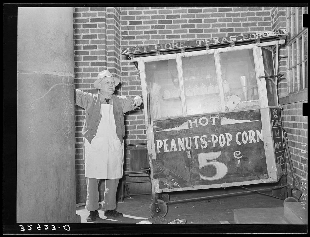 Popcorn man in front of bank. San Augustine, Texas by Russell Lee