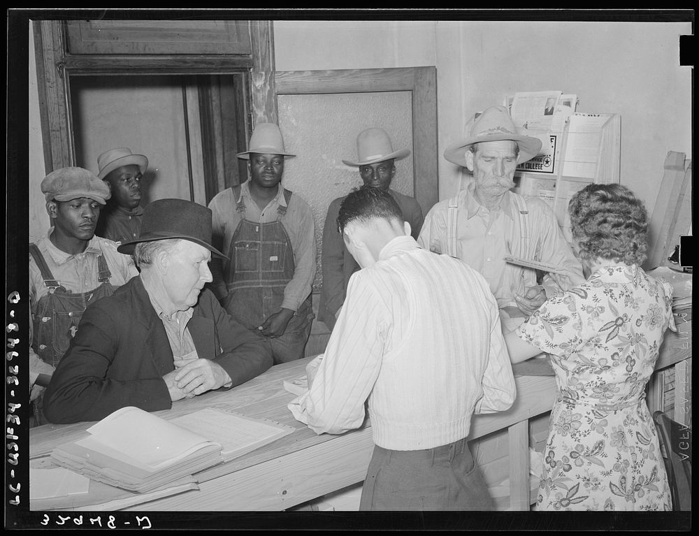Scene in county agent's office, San Augustine, Texas. Farmer is receiving his AAA check by Russell Lee
