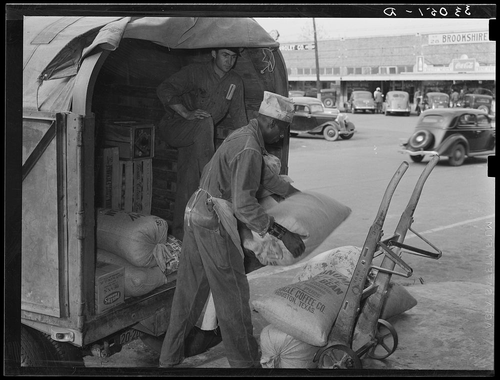 Unloading wholesale grocery wagon. San Augustine, Texas by Russell Lee