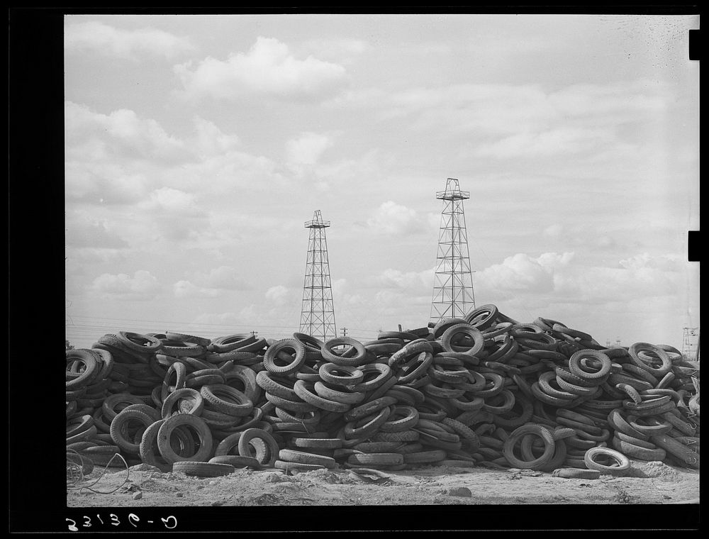 Piles of worn-out automobile tires in oil fields at Kilgore, Texas. Bad roads and heavy trucking in the oil fields cause…