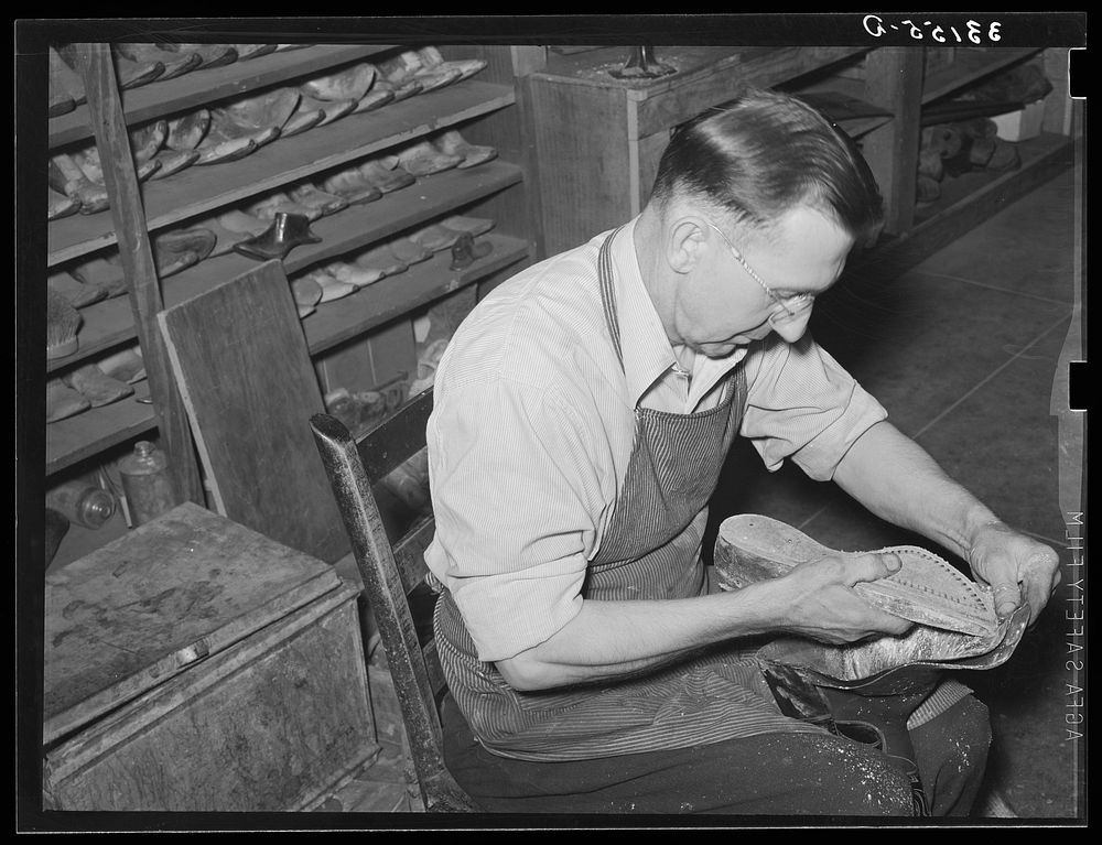 Bootmaker putting last and sole into upper part of boot. Boot shop, Alpine, Texas by Russell Lee