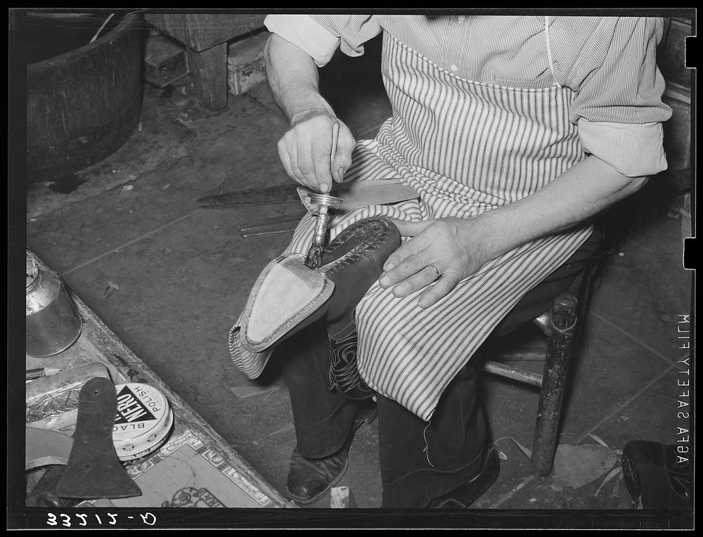 Applying glue to cement outer sole to the inner sole of the boot. Cowboy boot shop, Alpine, Texas by Russell Lee