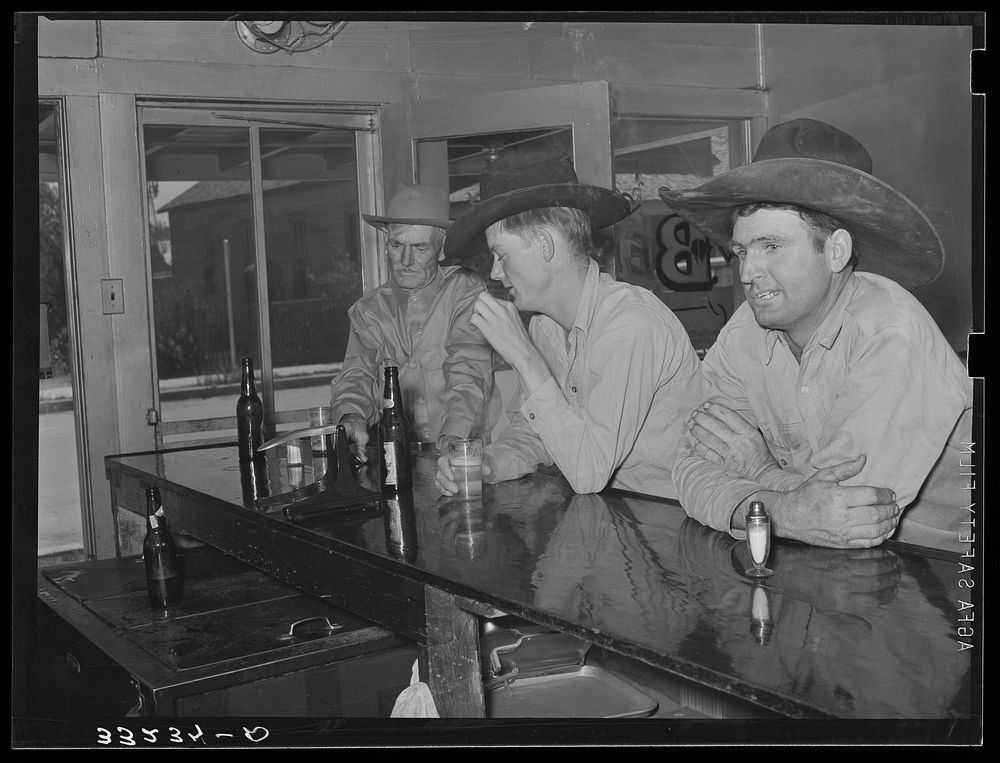 Cowboys in beer parlor. Alpine, Texas by Russell Lee