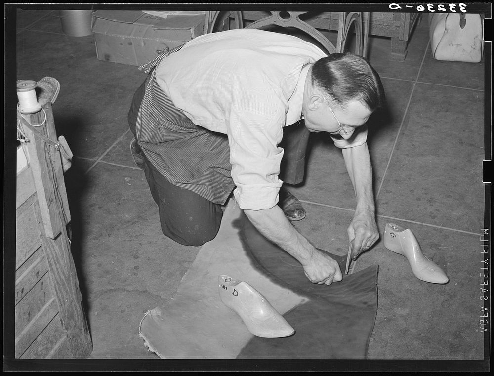 Cutting out of the sole of the boot from pattern traced from last. Bootmaking shop, Alpine, Texas by Russell Lee