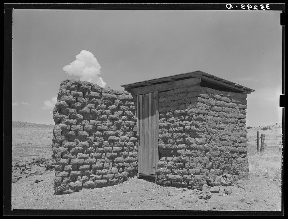 Adobe privy with windbreak. Old "Walking X" Ranch place near Marfa, Texas by Russell Lee