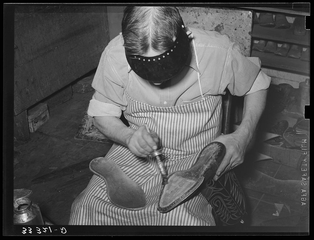 Applying cement to boot before attaching outer sole. Bootmaking shop, Alpine, Texas by Russell Lee