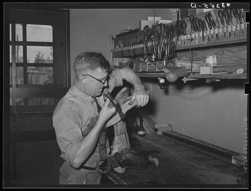 Repairing a saddle. Saddle shop, Alpine, Texas by Russell Lee